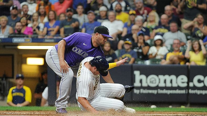 Jul 23, 2022; Milwaukee, Wisconsin, USA; Milwaukee Brewers right fielder Hunter Renfroe (12) scores on a wild pitch as Colorado Rockies relief pitcher Jhoulys Chacin (43) covers the plate in the sixth inning at American Family Field. Mandatory Credit: Michael McLoone-USA TODAY Sports