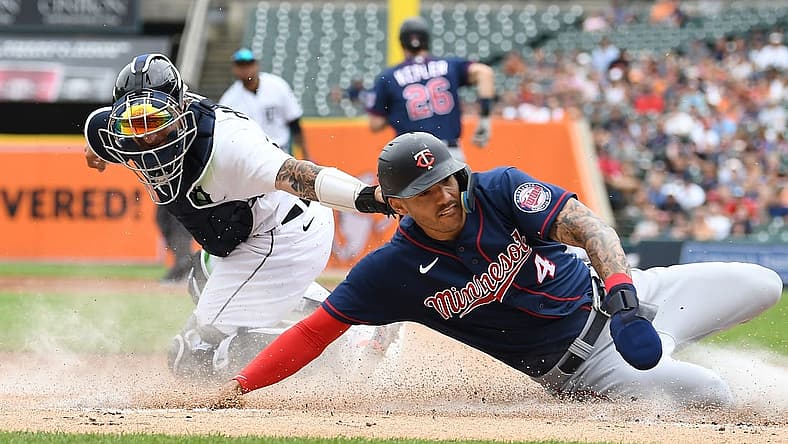 Jul 24, 2022; Detroit, Michigan, USA; Minnesota Twins shortstop Carlos Correa (4) slides safely into home plate ahead of the tag of Detroit Tigers catcher Eric Haase (13) on a fielder s choice hit by right fielder Max Kepler (not pictured) during the first inning at Comerica Park. Mandatory Credit: Lon Horwedel-USA TODAY Sports
