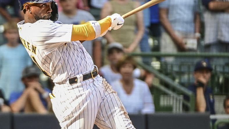 Jul 24, 2022; Milwaukee, Wisconsin, USA; Milwaukee Brewers designated hitter Andrew McCutchen (24) hits a RBI double in the eighth inning against the Colorado Rockies at American Family Field. Mandatory Credit: Benny Sieu-USA TODAY Sports