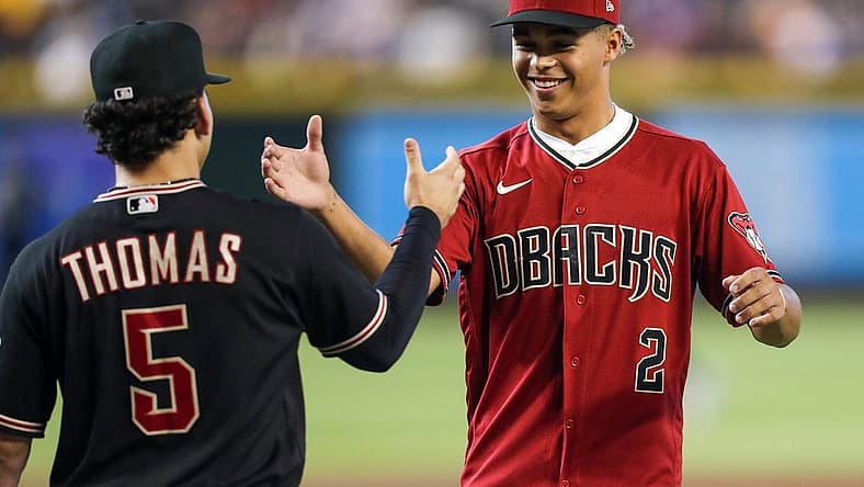 Diamondbacks Draft Druw Jones, right, shakes hands with Arizona Diamondbacks center fielder Alek Thomas (5), left, after throwing the opening pitch before the game against the Washington Nationals at Chase Field on Saturday, July 23, 2022, in Phoenix.

Uscp 7lzxvqcipg7dt8x01rk2 Original