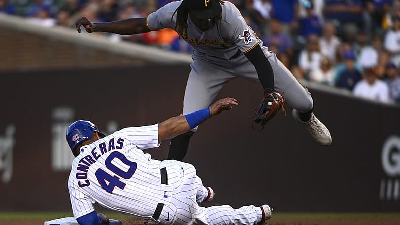 Jul 25, 2022; Chicago, Illinois, USA; Pittsburgh Pirates shortstop Oneil Cruz (top) tags out Chicago Cubs catcher Willson Contreras (40) during the first inning at Wrigley Field. Mandatory Credit: Matt Marton-USA TODAY Sports