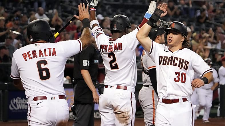Jul 25, 2022; Phoenix, Arizona, USA; Arizona Diamondbacks designated hitter David Peralta (6) and left fielder Jake McCarthy (30) celebrate with shortstop Geraldo Perdomo (2) after scoring runs against the San Francisco Giants during the sixth inning at Chase Field. Mandatory Credit: Joe Camporeale-USA TODAY Sports