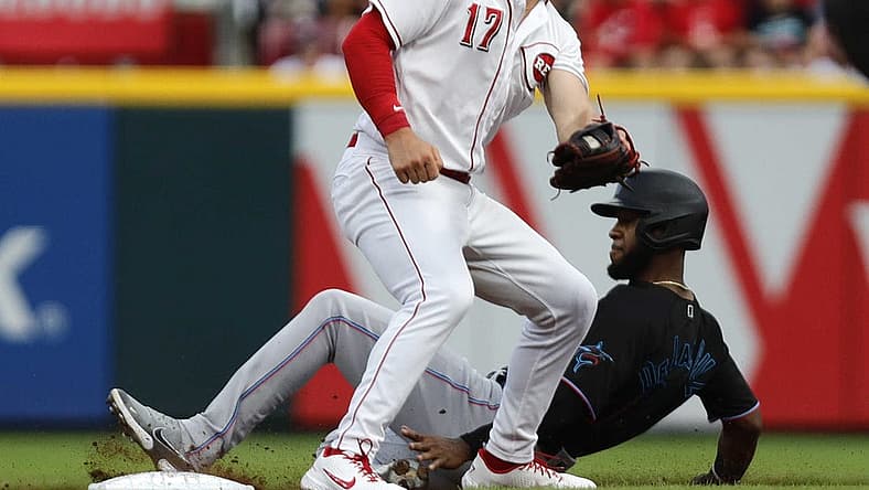 Jul 26, 2022; Cincinnati, Ohio, USA; Miami Marlins right fielder Bryan De La Cruz (14) steals second against Cincinnati Reds shortstop Kyle Farmer (17) during the sixth inning at Great American Ball Park. Mandatory Credit: David Kohl-USA TODAY Sports