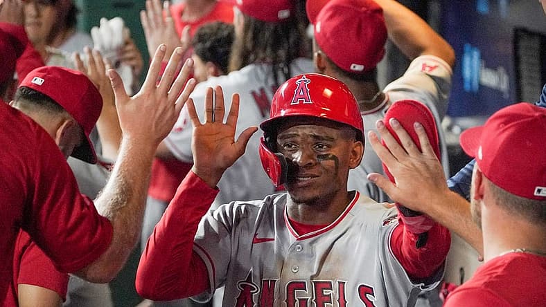 Jul 26, 2022; Kansas City, Missouri, USA; Los Angeles Angels center fielder Magneuris Sierra (37) is congratulated in the dugout against the Kansas City Royals after scoring in the seventh inning of the game at Kauffman Stadium. Mandatory Credit: Denny Medley-USA TODAY Sports