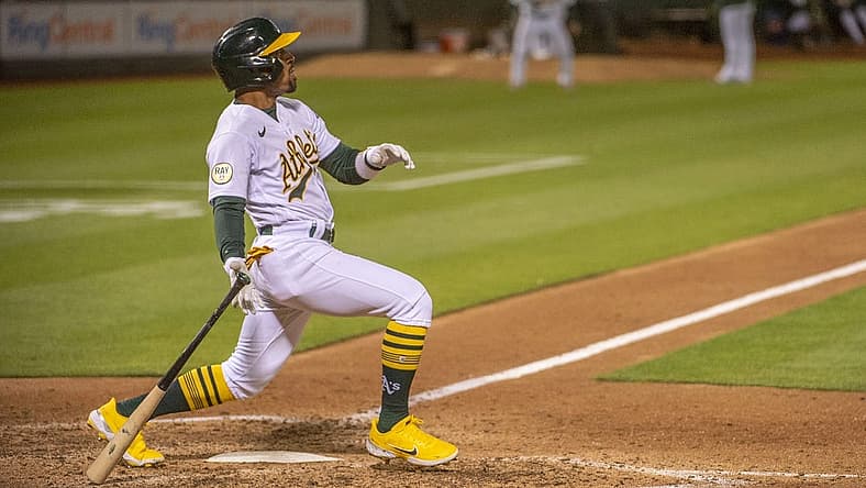 Jul 26, 2022; Oakland, California, USA; Oakland Athletics second baseman Tony Kemp (5) hits an rbi double during the eighth inning against the Houston Astros at RingCentral Coliseum. Mandatory Credit: Ed Szczepanski-USA TODAY Sports