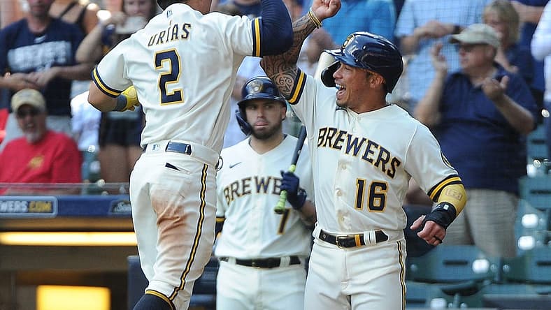 Jul 27, 2022; Milwaukee, Wisconsin, USA; Milwaukee Brewers shortstop Luis Urias (2), left celebrates his home run with Milwaukee Brewers second baseman Kolten Wong (16) in the fifth inning against the Minnesota Twins at American Family Field. Mandatory Credit: Michael McLoone-USA TODAY Sports
