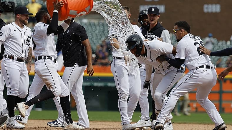 Jul 27, 2022; Detroit, Michigan, USA; Detroit Tigers right fielder Victor Reyes (22) receives congratulations from teammates after he hits a walk off two RBI double in the ninth inning against the San Diego Padres at Comerica Park. Mandatory Credit: Rick Osentoski-USA TODAY Sports