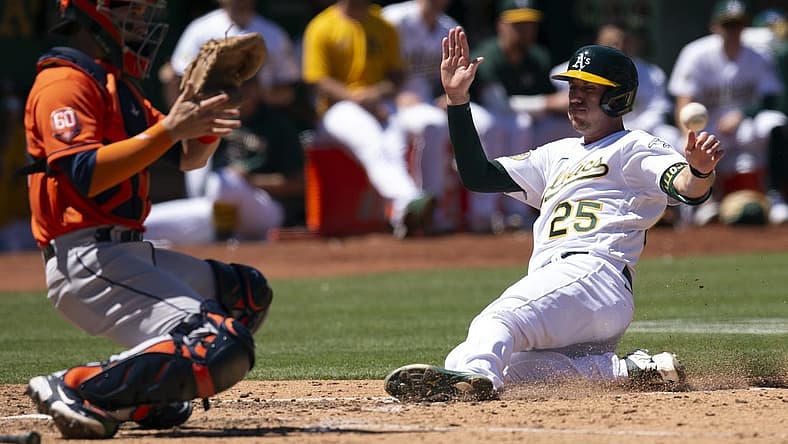 Jul 27, 2022; Oakland, California, USA; Oakland Athletics left fielder Stephen Piscotty (25) slides safely home ahead of the relay to Houston Astros catcher Korey Lee (38) on an RBI single by Skye Bolt during the seventh inning at RingCentral Coliseum. Mandatory Credit: D. Ross Cameron-USA TODAY Sports
