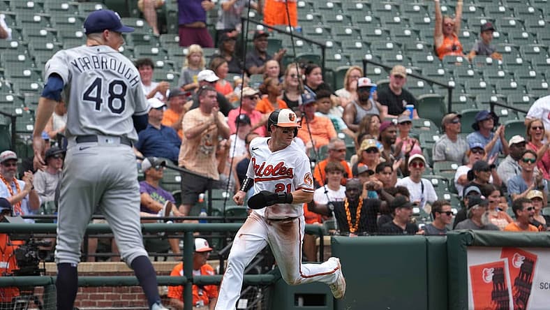 Jul 28, 2022; Baltimore, Maryland, USA; Baltimore Orioles outfielder Austin Hays (21) scores in the third inning against the Tampa Bay Rays at Oriole Park at Camden Yards. Mandatory Credit: Mitch Stringer-USA TODAY Sports