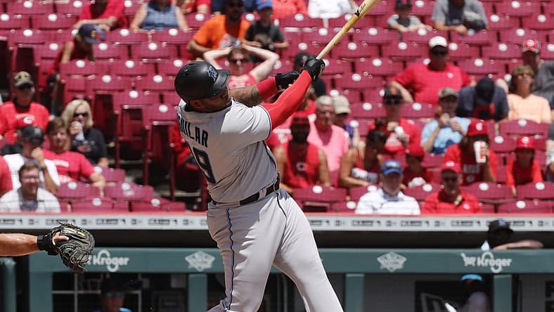 Jul 28, 2022; Cincinnati, Ohio, USA; Miami Marlins designated hitter Jesus Aguilar (99) hits a two-run home run against the Cincinnati Reds during the third inning at Great American Ball Park. Mandatory Credit: David Kohl-USA TODAY Sports