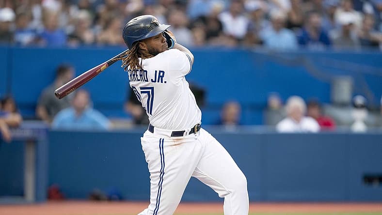 Jul 28, 2022; Toronto, Ontario, CAN; Toronto Blue Jays first baseman Vladimir Guerrero Jr. (27) hits a double against the Detroit Tigers during the first inning at Rogers Centre. Mandatory Credit: Nick Turchiaro-USA TODAY Sports