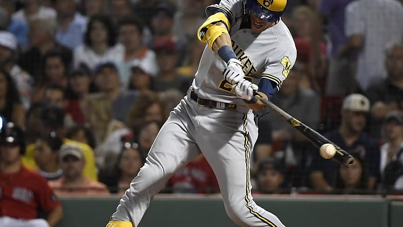 Jul 29, 2022; Boston, Massachusetts, USA; Milwaukee Brewers left fielder Christian Yelich (22) hits a double during the sixth inning against the Boston Red Sox at Fenway Park. Mandatory Credit: Bob DeChiara-USA TODAY Sports