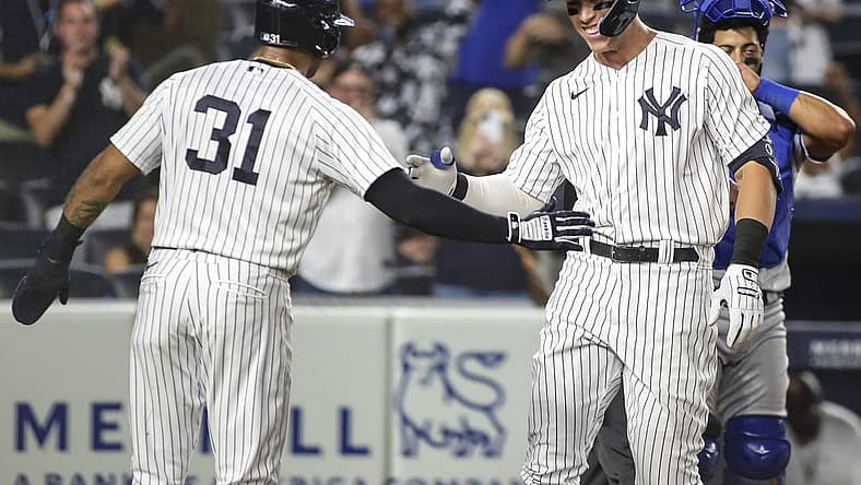 Jul 29, 2022; Bronx, New York, USA;  New York Yankees center fielder Aaron Hicks (31) greets right fielder Aaron Judge (99) after he hit a grand slam home run in the eighth inning against the Kansas City Royals at Yankee Stadium. Mandatory Credit: Wendell Cruz-USA TODAY Sports