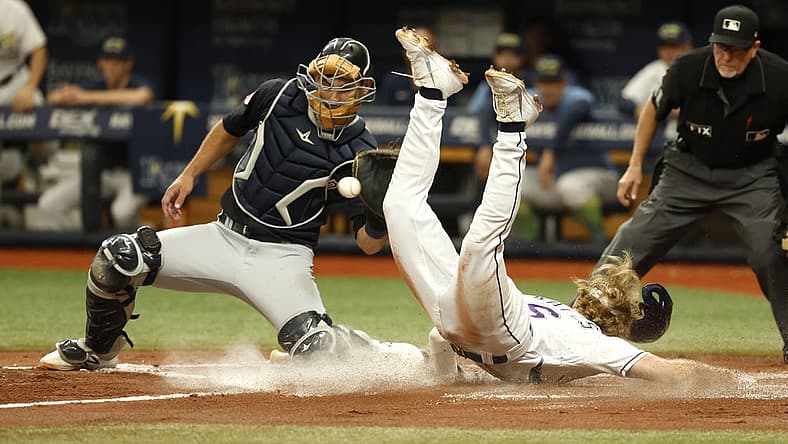 Jul 30, 2022; St. Petersburg, Florida, USA; Tampa Bay Rays shortstop Taylor Walls (6) slides safe into home plate as Cleveland Guardians catcher Luke Maile (12) attempted to tag him out during the second inning at Tropicana Field. Mandatory Credit: Kim Klement-USA TODAY Sports