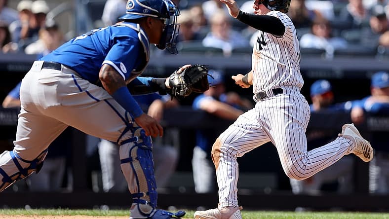 Jul 30, 2022; Bronx, New York, USA; New York Yankees catcher Jose Trevino (39) scores on a sacrifice fly by left fielder Andrew Benintendi (not pictured) in front of Kansas City Royals catcher Salvador Perez (13) during the fourth inning at Yankee Stadium. Mandatory Credit: Brad Penner-USA TODAY Sports