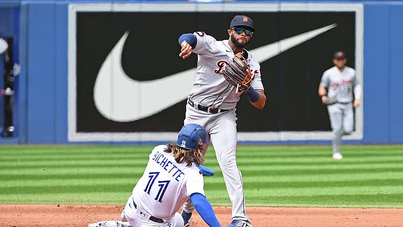 Jul 31, 2022; Toronto, Ontario, CAN; Detroit Tigers second base Willi Castro (9) turns a double play over Toronto Blue Jays short stop Bo Bichette (11) in the fourth inning at Rogers Centre. Mandatory Credit: Gerry Angus-USA TODAY Sports