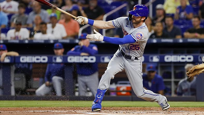 Jul 31, 2022; Miami, Florida, USA; New York Mets right fielder Tyler Naquin (25) hits a single during the first inning against the Miami Marlins at loanDepot Park. Mandatory Credit: Sam Navarro-USA TODAY Sports