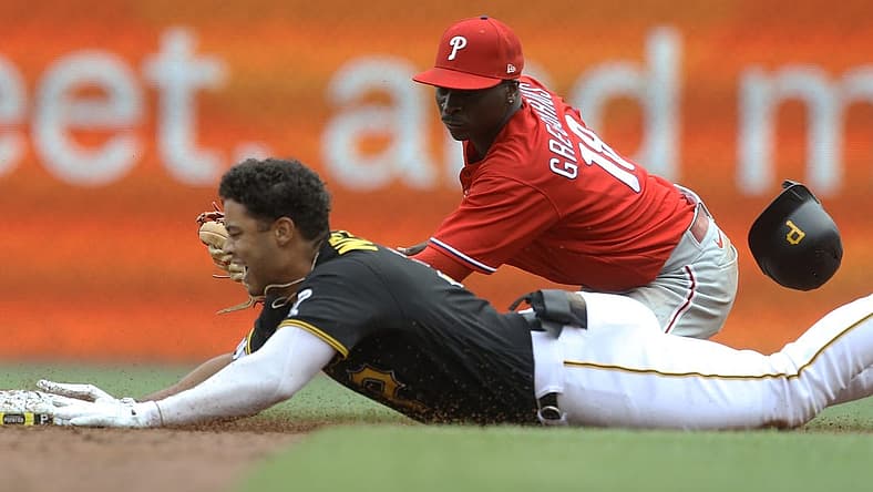 Jul 31, 2022; Pittsburgh, Pennsylvania, USA; Pittsburgh Pirates designated hitter Cal Mitchell (31) slides into second base for an RBI double as Philadelphia Phillies shortstop Didi Gregorius (18) looks to make a tag during the third inning at PNC Park. Mandatory Credit: Charles LeClaire-USA TODAY Sports