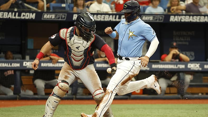 Jul 31, 2022; St. Petersburg, Florida, USA; Tampa Bay Rays second baseman Isaac Paredes (17) scores a run as Cleveland Guardians catcher Austin Hedges (17) attempts to tag him out during the second inning at Tropicana Field. Mandatory Credit: Kim Klement-USA TODAY Sports