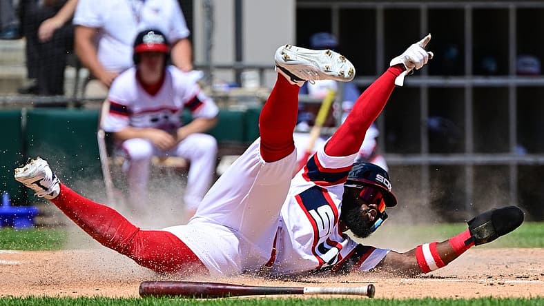 Jul 31, 2022; Chicago, Illinois, USA; Chicago White Sox second baseman Josh Harrison (5) celebrates while sliding at home to score in the second inning against the Oakland Athletics at Guaranteed Rate Field. Mandatory Credit: Quinn Harris-USA TODAY Sports