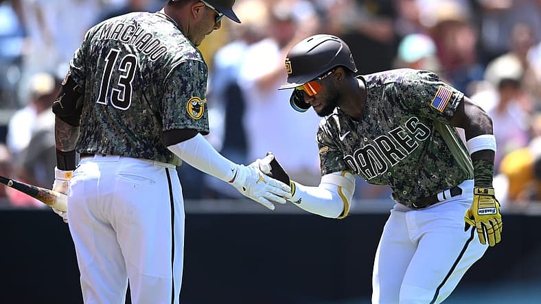 Jul 31, 2022; San Diego, California, USA; San Diego Padres left fielder Jurickson Profar (right) is congratulated by third baseman Manny Machado (13) after hitting a home run during the third inning against the San Diego Padres at Petco Park. Mandatory Credit: Orlando Ramirez-USA TODAY Sports