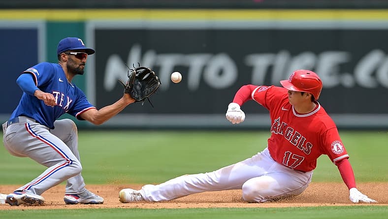 Jul 31, 2022; Anaheim, California, USA; Los Angeles Angels starting pitcher Shohei Ohtani (17) is caught stealing as he is tagged out by Texas Rangers second baseman Marcus Semien (2) in the third inning at Angel Stadium. Mandatory Credit: Jayne Kamin-Oncea-USA TODAY Sports