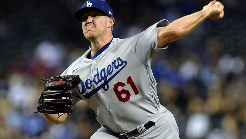 Jun 19, 2021; Phoenix, Arizona, USA; Los Angeles Dodgers relief pitcher Garrett Cleavinger (61) pitches against the Arizona Diamondbacks during the ninth inning at Chase Field. Mandatory Credit: Joe Camporeale-USA TODAY Sports