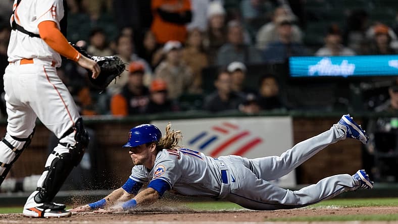 May 24, 2022; San Francisco, California, USA; New York Mets center fielder Travis Jankowski (16) drives home to score against the San Francisco Giants during the ninth inning at Oracle Park. Mandatory Credit: John Hefti-USA TODAY Sports