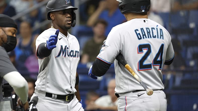 May 25, 2022; St. Petersburg, Florida, USA; Miami Marlins right fielder Jorge Soler (12) is congratulated by right fielder Avisail Garcia (24) as he hits a home run during the fourth inning against the Tampa Bay Rays at Tropicana Field. Mandatory Credit: Kim Klement-USA TODAY Sports