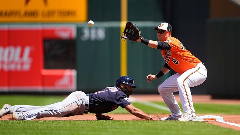 Jun 5, 2022; Baltimore, Maryland, USA; Baltimore Orioles first baseman Ryan Mountcastle (6) receives a throw with Cleveland Guardians shortstop Amed Rosario (1) diving back to the first base bag during the first inning at Oriole Park at Camden Yards. Mandatory Credit: Gregory Fisher-USA TODAY Sports