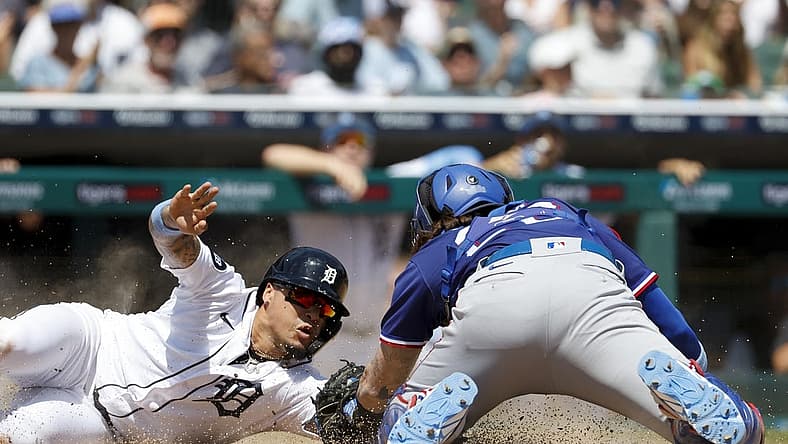 Jun 19, 2022; Detroit, Michigan, USA; Detroit Tigers shortstop Javier Baez (28) slides in safe at home ahead of the tag by Texas Rangers catcher Jonah Heim (28) in the fifth inning at Comerica Park. Mandatory Credit: Rick Osentoski-USA TODAY Sports