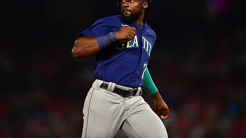 June 25, 2022; Anaheim, California, USA; Seattle Mariners pinch runner Taylor Trammell (20) reaches third against the Los Angeles Angels during the seventh inning at Angel Stadium. Mandatory Credit: Gary A. Vasquez-USA TODAY Sports