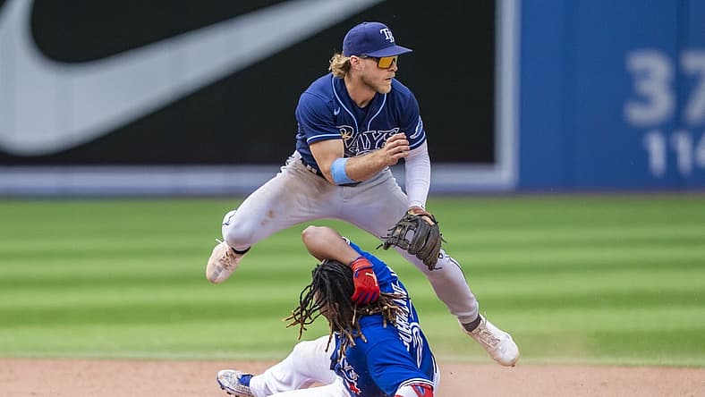 Jul 3, 2022; Toronto, Ontario, CAN; Toronto Blue Jays first baseman Vladimir Guerrero Jr. (27) slides into second base against Tampa Bay Rays shortstop Taylor Walls (6) during the ninth inning at Rogers Centre. Mandatory Credit: Kevin Sousa-USA TODAY Sports