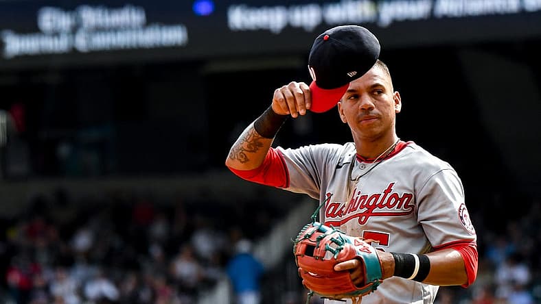 Jul 9, 2022; Cumberland, Georgia, USA; Washington Nationals left fielder Ehire Adrianza (5) readjusts his hat during a game against the Atlanta Braves at Truist Park. Mandatory Credit: Larry Robinson-USA TODAY Sports