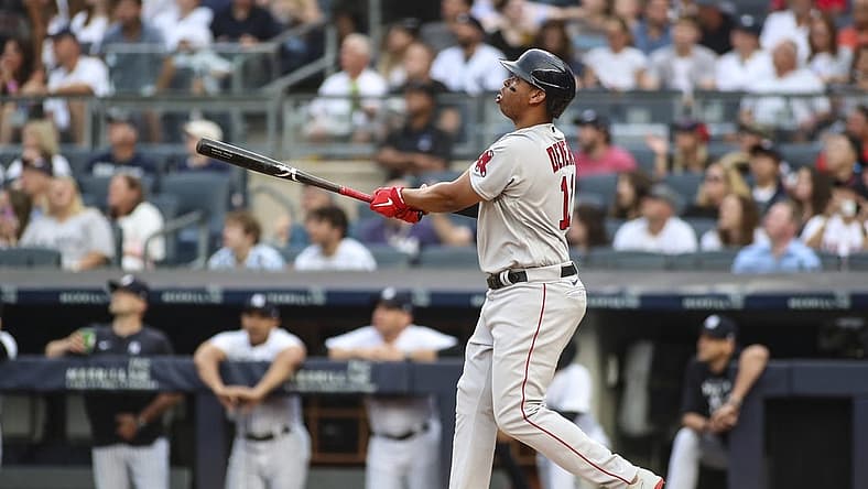 Jul 16, 2022; Bronx, New York, USA; Boston Red Sox third baseman Rafael Devers (11) hits a solo home run in the first inning against the New York Yankees at Yankee Stadium. Mandatory Credit: Wendell Cruz-USA TODAY Sports