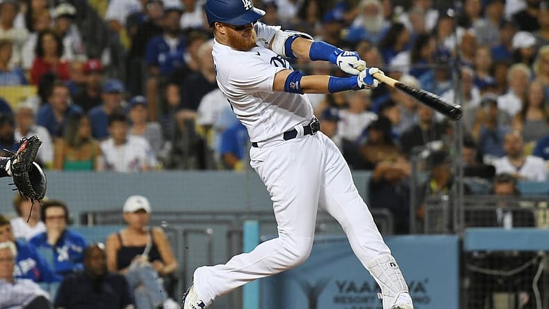 Jul 21, 2022; Los Angeles, California, USA; Los Angeles Dodgers third baseman Justin Turner (10) gets a hit to score two runs in the third inning against the San Francisco Giants at Dodger Stadium. Mandatory Credit: Richard Mackson-USA TODAY Sports