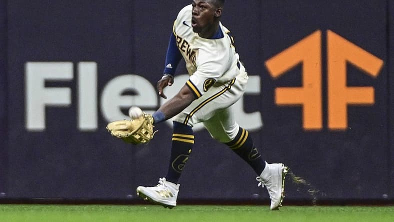 Jul 26, 2022; Milwaukee, Wisconsin, USA;  Milwaukee Brewers center fielder Jonathan Davis (3) catches ball hit by Minnesota Twins third baseman Gio Urshela (not pictured) in the seventh inning at American Family Field. Mandatory Credit: Benny Sieu-USA TODAY Sports