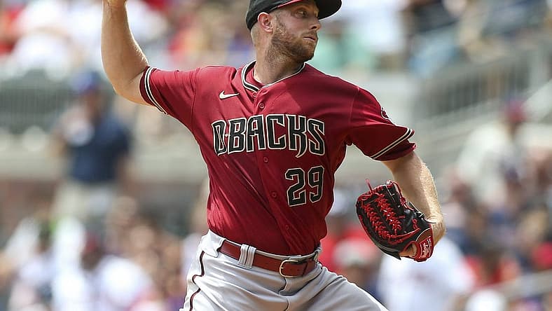 Jul 31, 2022; Atlanta, Georgia, USA; Arizona Diamondbacks starting pitcher Merrill Kelly (29) throws against the Atlanta Braves in the second inning at Truist Park. Mandatory Credit: Brett Davis-USA TODAY Sports