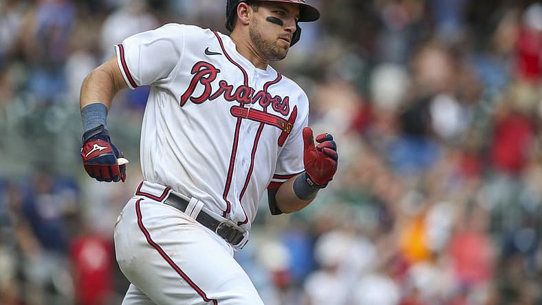Jul 31, 2022; Atlanta, Georgia, USA; Atlanta Braves third baseman Austin Riley (27) hits a game-winning RBI double against the Arizona Diamondbacks in the ninth inning at Truist Park. Mandatory Credit: Brett Davis-USA TODAY Sports