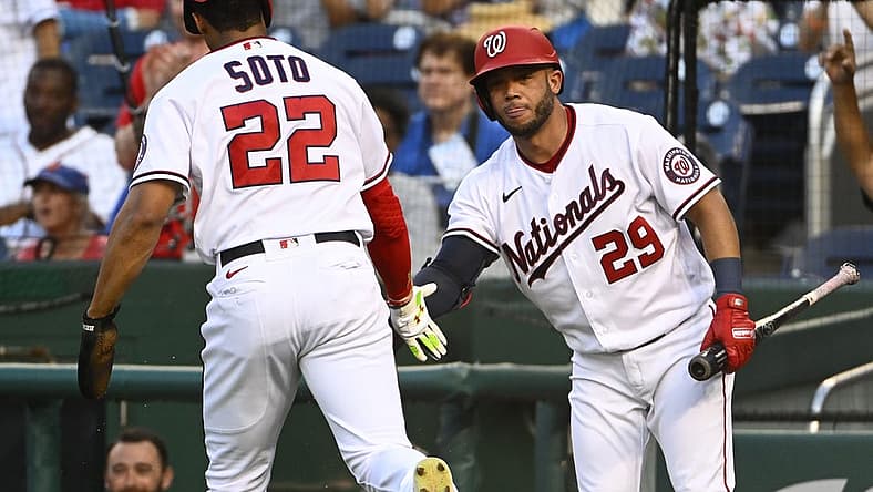 Aug 1, 2022; Washington, District of Columbia, USA; Washington Nationals right fielder Juan Soto (22) is congratulated by left fielder Yadiel Hernandez (29) after scoring a run against the New York Mets during the first inning at Nationals Park. Mandatory Credit: Brad Mills-USA TODAY Sports
