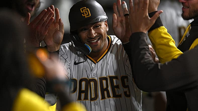 Aug 1, 2022; San Diego, California, USA; San Diego Padres center fielder Trent Grisham (2) is congratulated in the dugout after hitting a home run against the Colorado Rockies during the seventh inning at Petco Park. Mandatory Credit: Orlando Ramirez-USA TODAY Sports