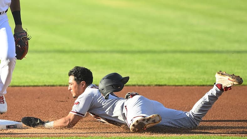 Aug 2, 2022; Cleveland, Ohio, USA; Arizona Diamondbacks third baseman Josh Rojas (10) steals second base in the first inning against the Cleveland Guardians at Progressive Field. Mandatory Credit: David Richard-USA TODAY Sports