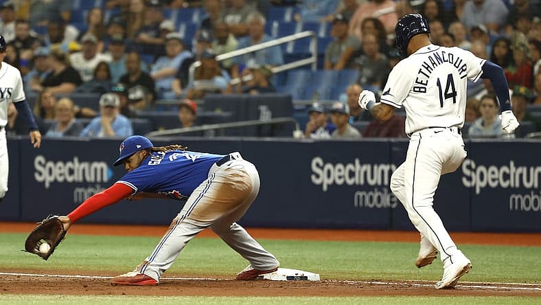 Aug 2, 2022; St. Petersburg, Florida, USA; Toronto Blue Jays first baseman Vladimir Guerrero Jr. (27) forces out Tampa Bay Rays first baseman Christian Bethancourt (14) during the second inning at Tropicana Field. Mandatory Credit: Kim Klement-USA TODAY Sports