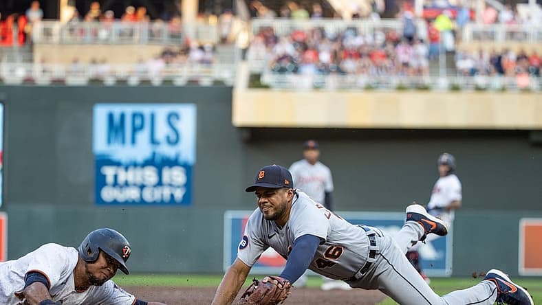 Aug 2, 2022; Minneapolis, Minnesota, USA; Minnesota Twins second baseman Luis Arraez (2) slides safely into third base beating the tag of Detroit Tigers third baseman Jeimer Candelario (46) during the third inning at Target Field. Mandatory Credit: Jordan Johnson-USA TODAY Sports