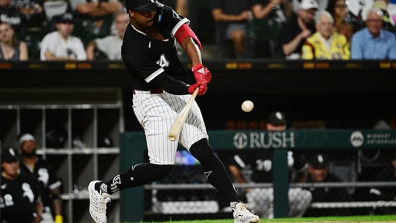 Aug 2, 2022; Chicago, Illinois, USA; Chicago White Sox left fielder Eloy Jimenez (74) hits a sacrifice fly in the sixth inning against the Kansas City Royals at Guaranteed Rate Field. Mandatory Credit: Quinn Harris-USA TODAY Sports