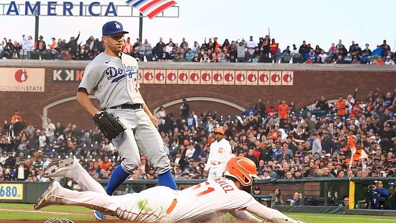 Aug 2, 2022; San Francisco, California, USA; San Francisco Giants right fielder Luis Gonzalez (51) scores ahead of Los Angeles Dodgers starting pitcher Tyler Anderson (31) on a wild pitch during the fourth inning at Oracle Park. Mandatory Credit: Kelley L Cox-USA TODAY Sports