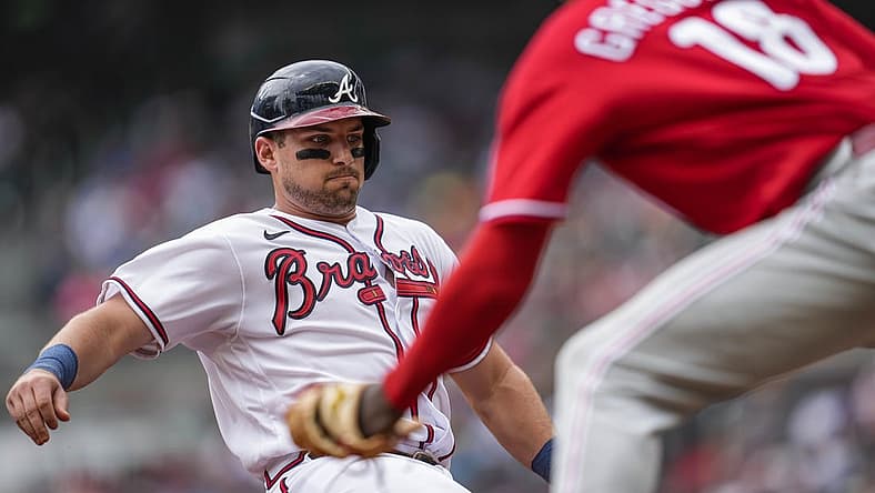 Aug 3, 2022; Cumberland, Georgia, USA; Atlanta Braves third baseman Austin Riley (27) is tagged out at third base by Philadelphia Phillies shortstop Didi Gregorius (18) during the second inning at Truist Park. Mandatory Credit: Dale Zanine-USA TODAY Sports