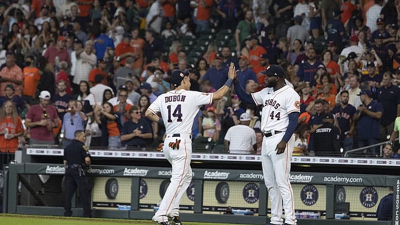 Aug 3, 2022; Houston, Texas, USA; Houston Astros center fielder Mauricio Dubon (14) and designated hitter Yordan Alvarez (44) celebrate their win against the Boston Red Sox in the ninth at Minute Maid Park. Mandatory Credit: Thomas Shea-USA TODAY Sports