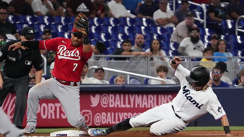 Aug 3, 2022; Miami, Florida, USA; Miami Marlins second baseman Luke Williams (46) steals third base ahead of the tag of Cincinnati Reds third baseman Donovan Solano (7) in the third inning at loanDepot Park. Mandatory Credit: Jasen Vinlove-USA TODAY Sports