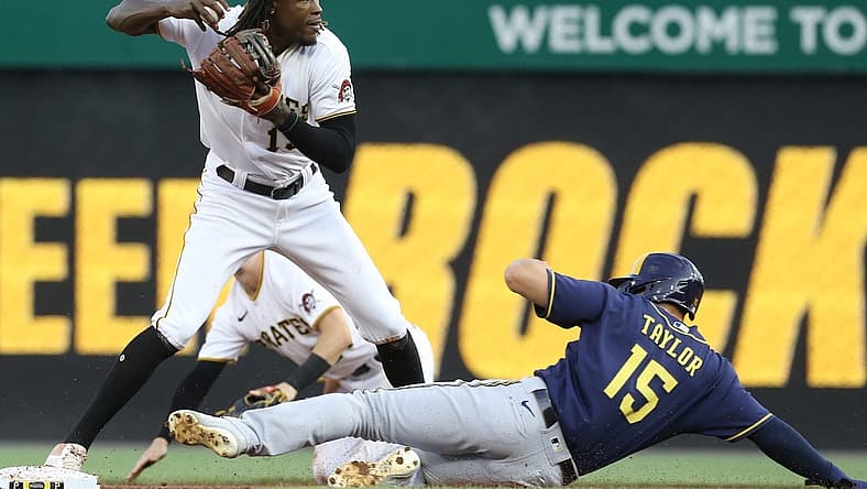 Aug 3, 2022; Pittsburgh, Pennsylvania, USA; Pittsburgh Pirates shortstop Oneil Cruz (15) looks to throw to first base after a force out of Milwaukee Brewers center fielder Tyrone Taylor (15) at second base during the second inning at PNC Park. Mandatory Credit: Charles LeClaire-USA TODAY Sports